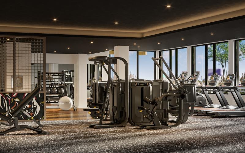 a gym with exercise machines and a large window